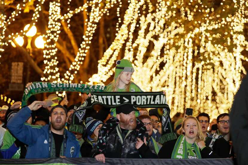 Seattle Sounders supporters take part in the march to the match before an MLS playoff match...