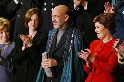 Laura Bush stood next to Hamid Karzai as President George W. Bush acknowledged the Afghan...