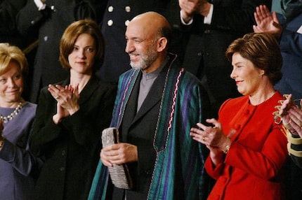 Laura Bush stood next to Hamid Karzai as President George W. Bush acknowledged the Afghan...