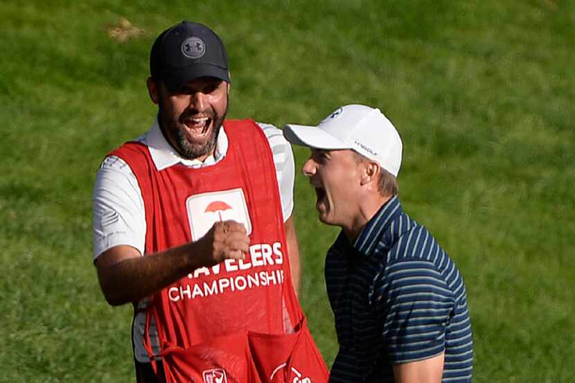 FILE - In a Sunday, June 25, 2017 file photo, Jordan Spieth celebrates with caddy Michael...