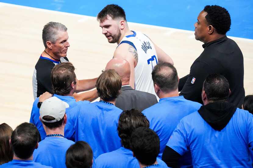 Officials step in to separate Dallas Mavericks guard Luka Doncic from Oklahoma City Thunder...