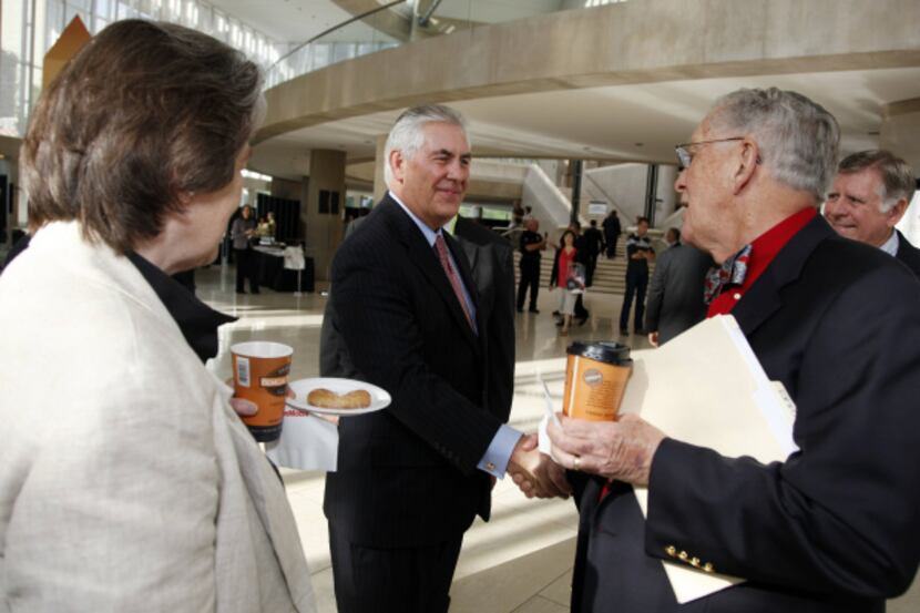 Exxon CEO Rex Tillerson (center) greeted Jo and Fred Cassell of Denton before the annual...