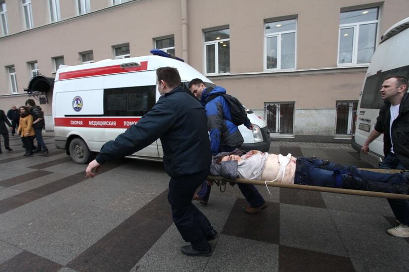 Men carry an injured person on a stretcher outside Technological Institute metro station in...