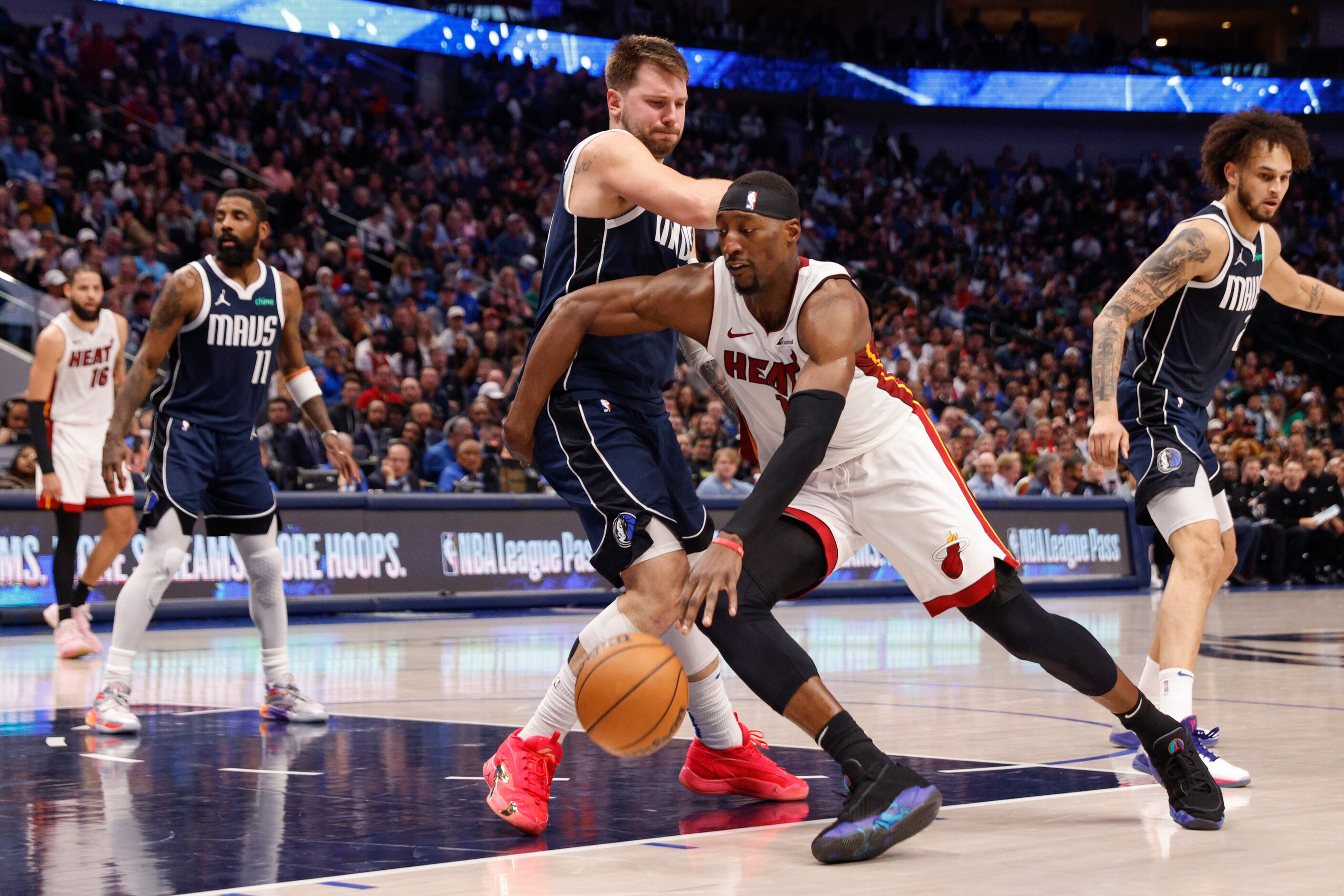 Dallas Mavericks guard Luka Doncic (77) defends Miami Heat center Bam Adebayo (13) during...