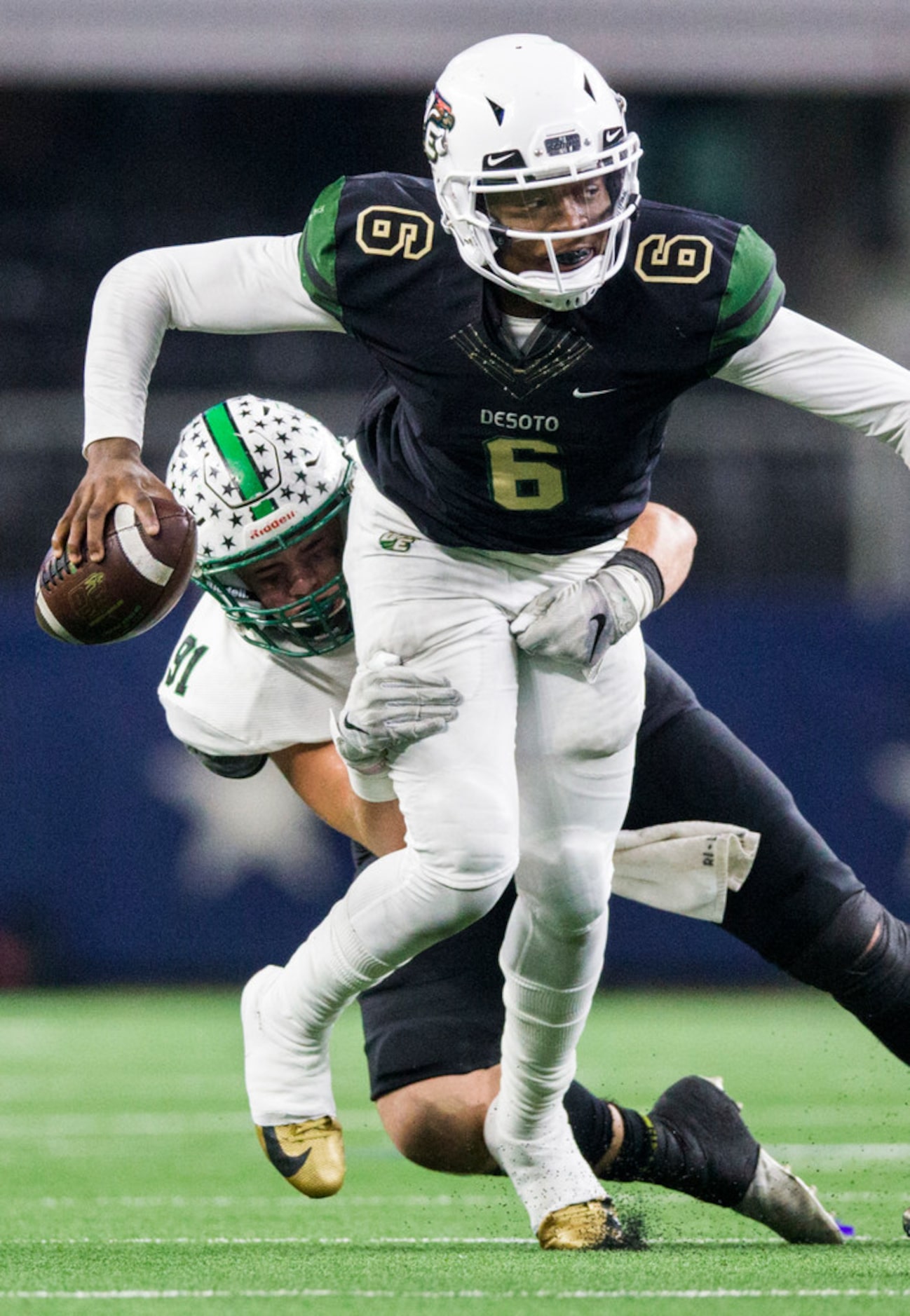 DeSoto quarterback Samari Collier (6) is tackled by Southlake Carroll defensive lineman...