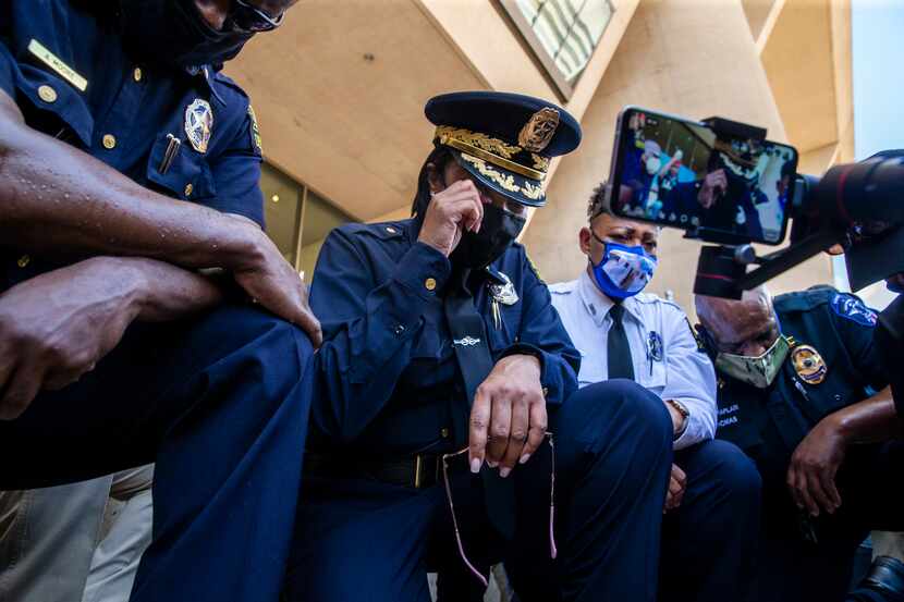 Chief U. Reneé Hall (center) weeps as she and other officers kneel for 8 minutes and 46...
