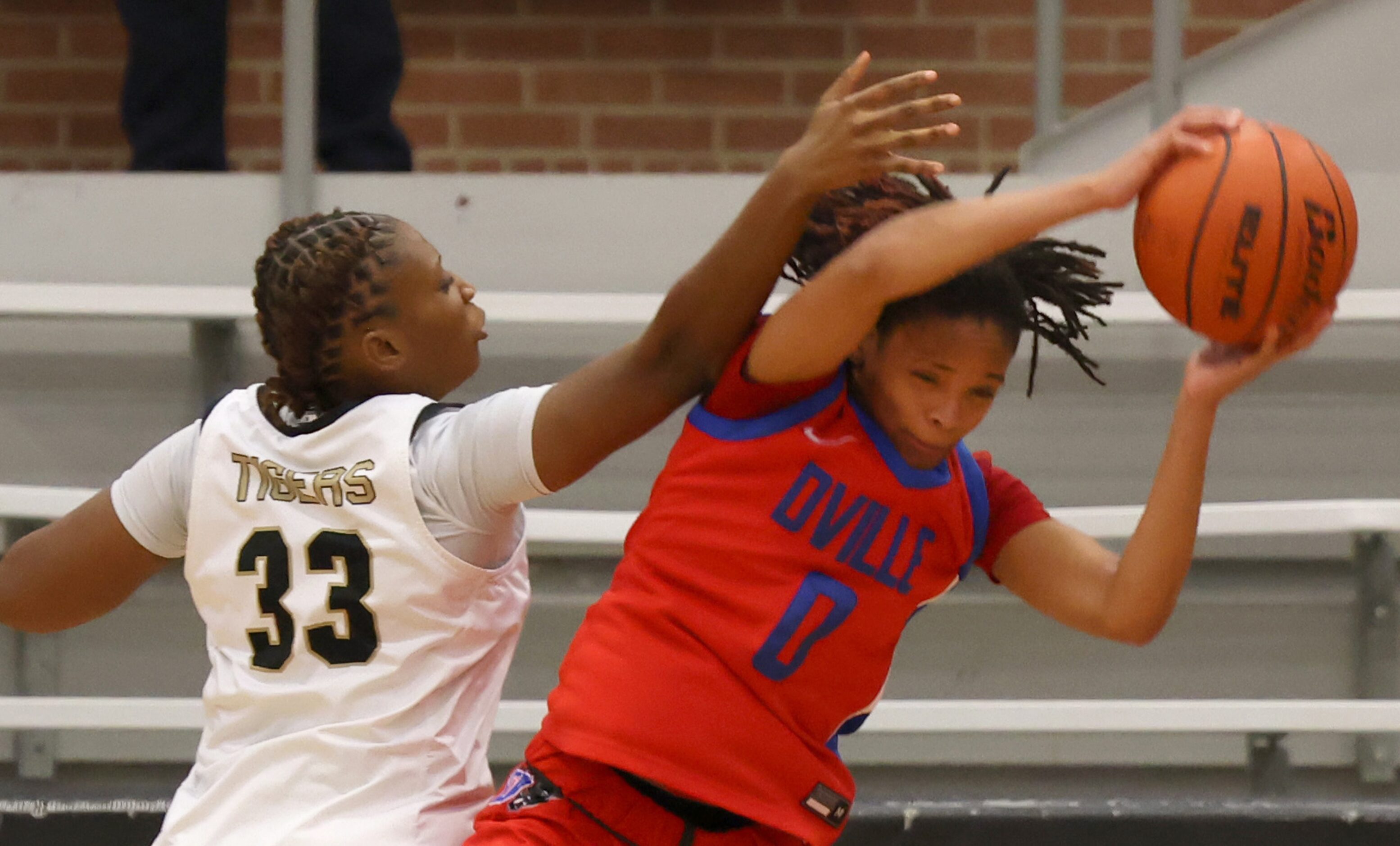 Duncanville guard Chloe Mann (0), right, pulls in a rebound against the challenge of...