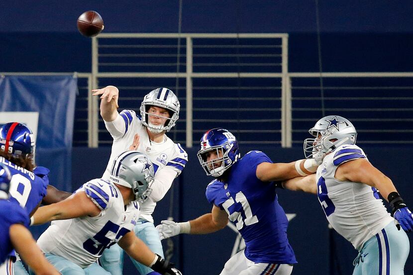 Dallas Cowboys quarterback Andy Dalton (14) throws over the New York Giants defensive line...