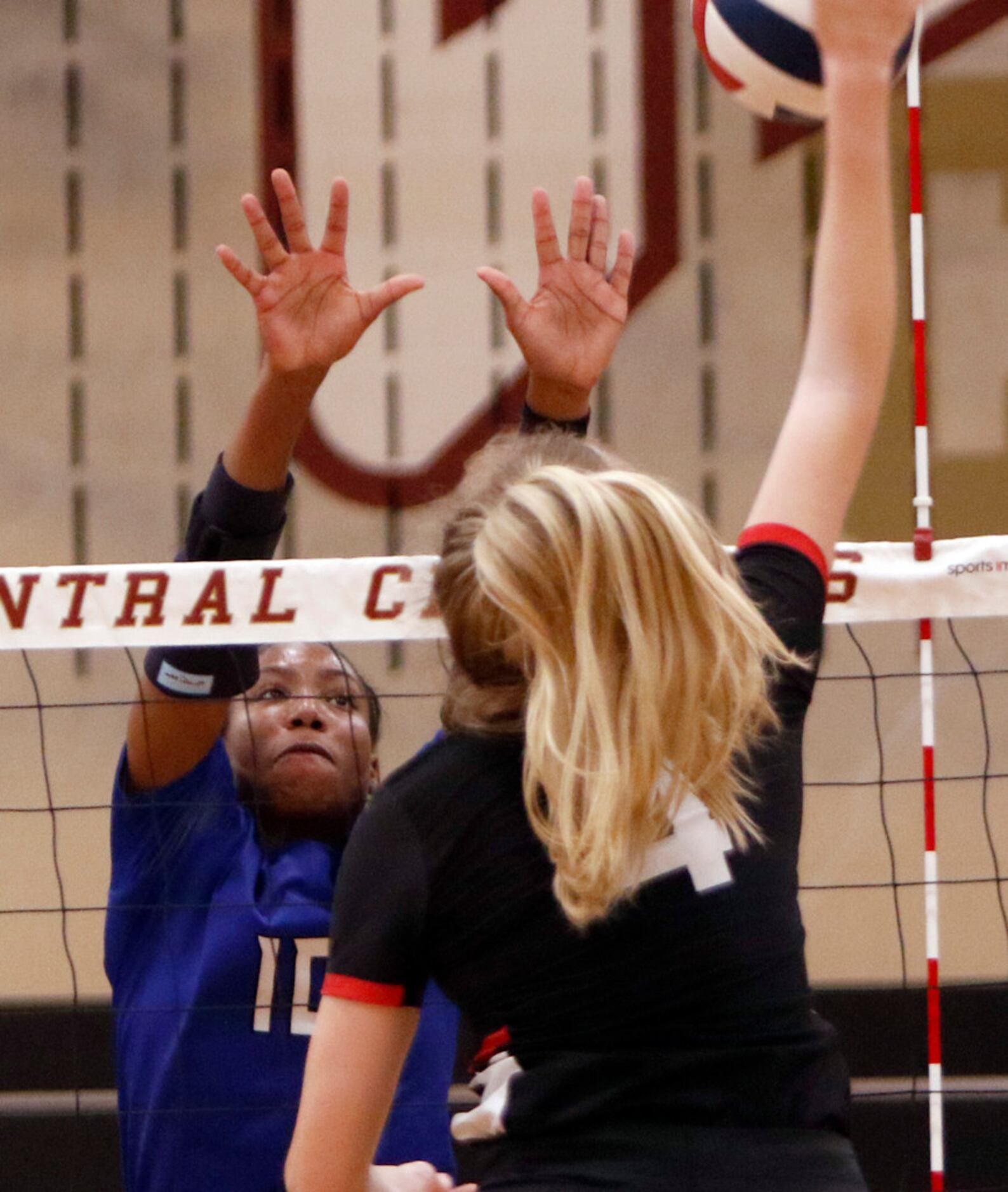 Trophy Club Byron Nelson outside hitter Charities Luper (10) leaps to defend a shot by...