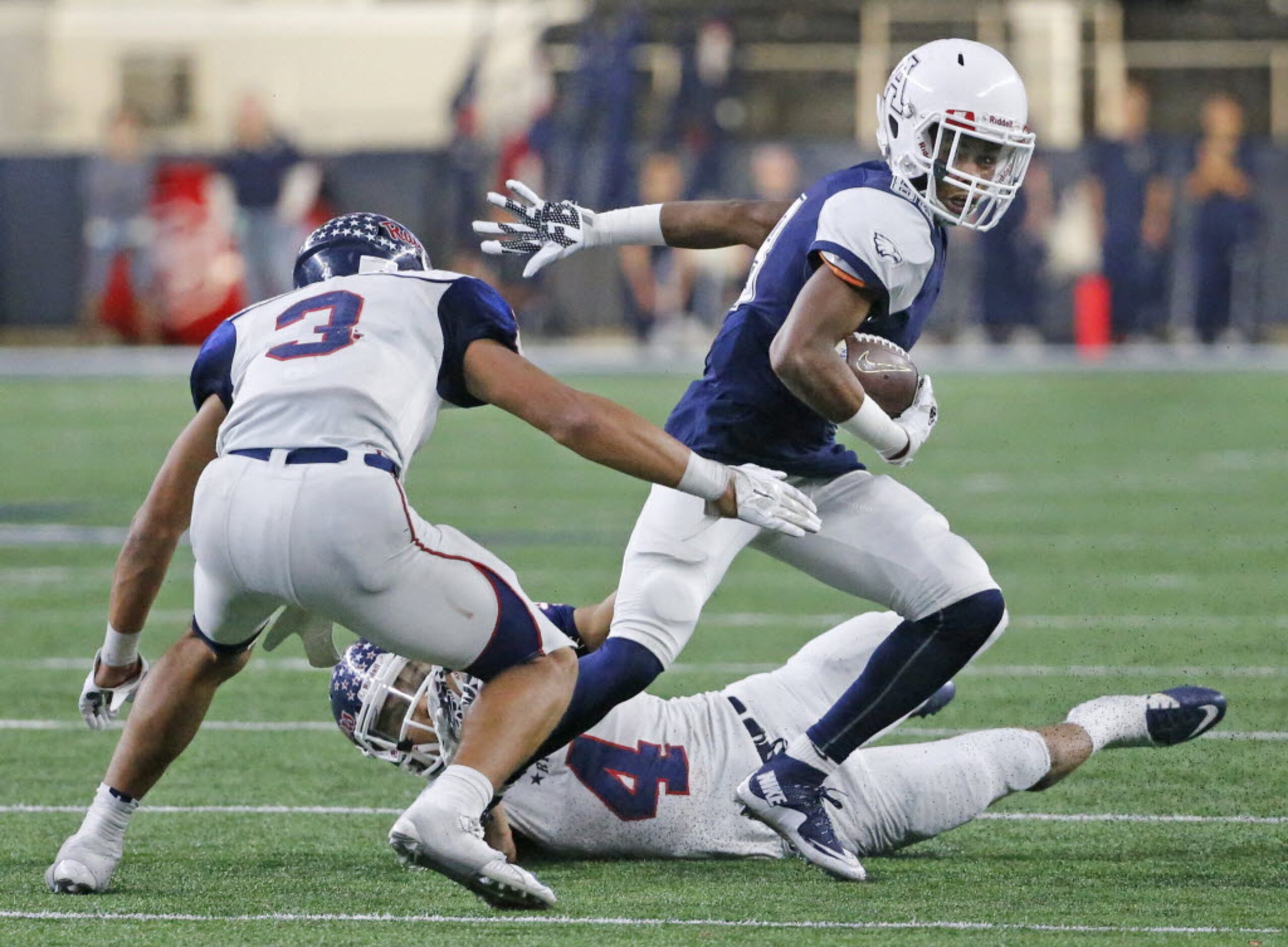 Allen receiver Jevon Jones looks for running room as Ryan defenders Spencer Sanders (3) and...