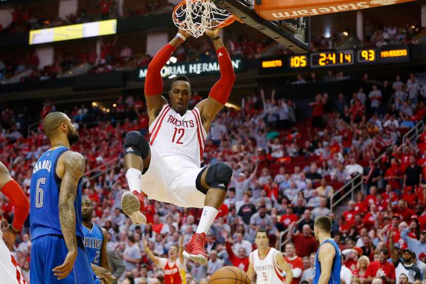 Houston Rockets center Dwight Howard (12) dunks the ball in front of Dallas Mavericks center...