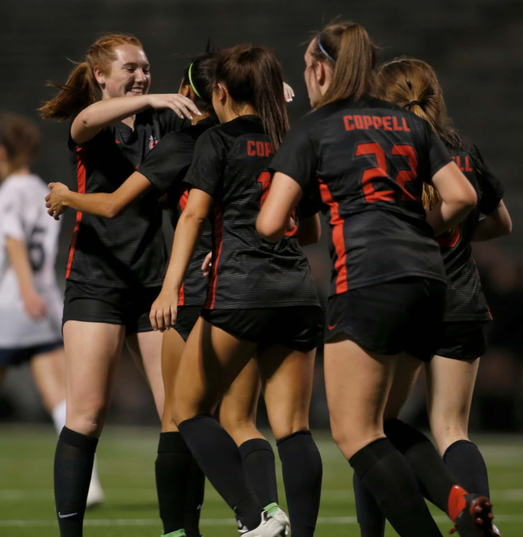 Coppell's Addison Martin (17), left, sports a Texas-sized smile as she hugs and...
