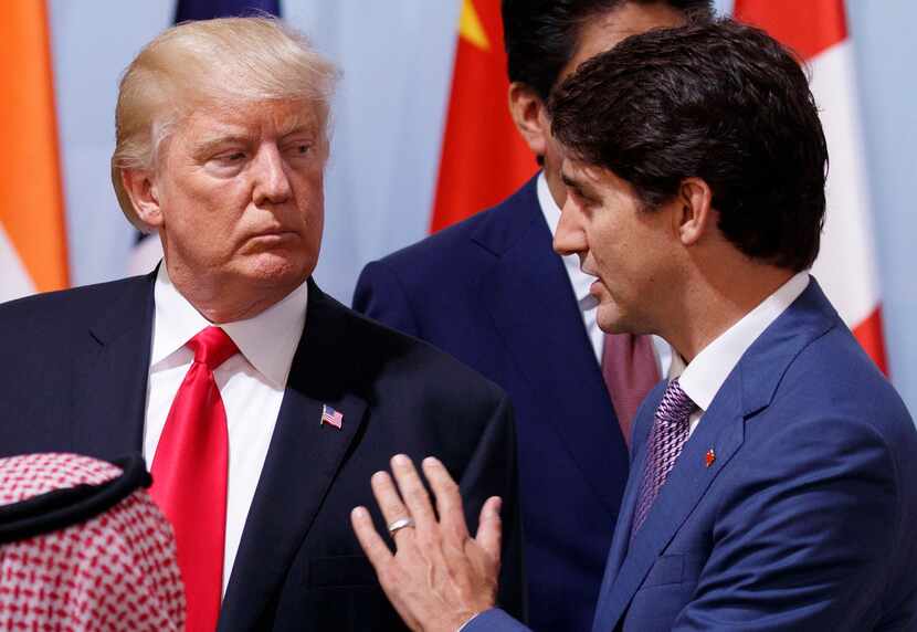 President Donald Trump talks with Canadian Prime Minister Justin Trudeau during the Women's...
