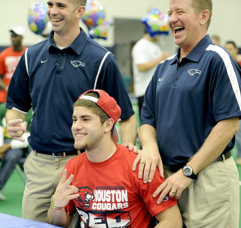 Andrew Rodriguez, who signed to play at Houston, poses for photos with offensive coordinator...