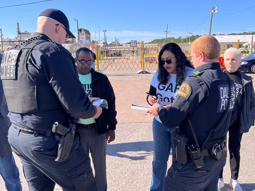 Local environmental activists Emmanuel Davis, center left, and Janie Cisneros, center right,...