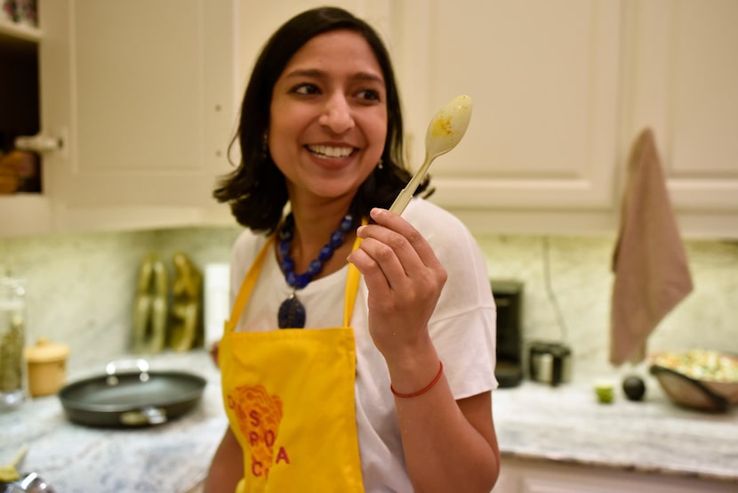 Priya Krishna smiles as she shows off a plastic spoon her mother has been using for years to...