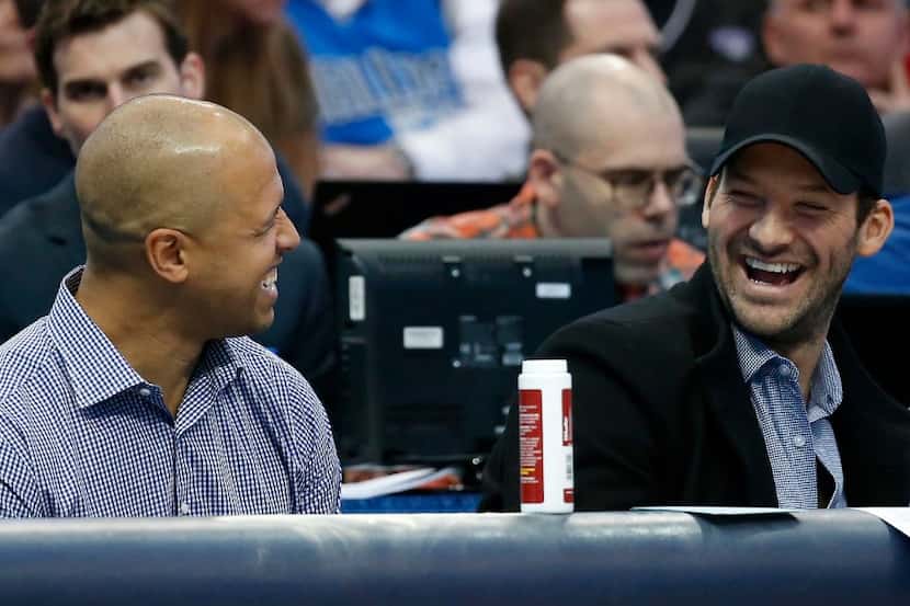 Tony Romo (right) shares a laugh with Miles Austin during the second quarter of the Dallas...