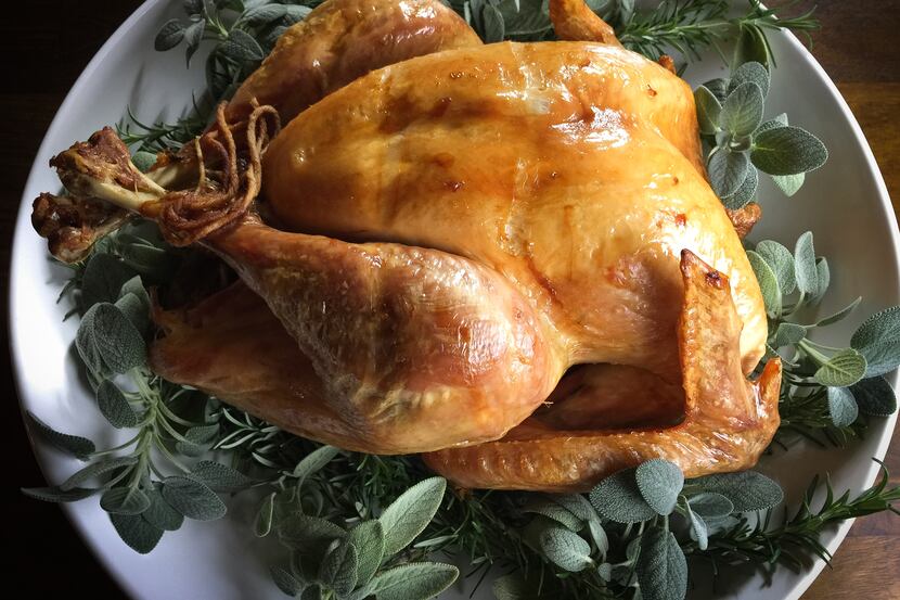 A dry-brined roasted turkey, served with Cognac sauce (not gravy!), is the centerpiece of...