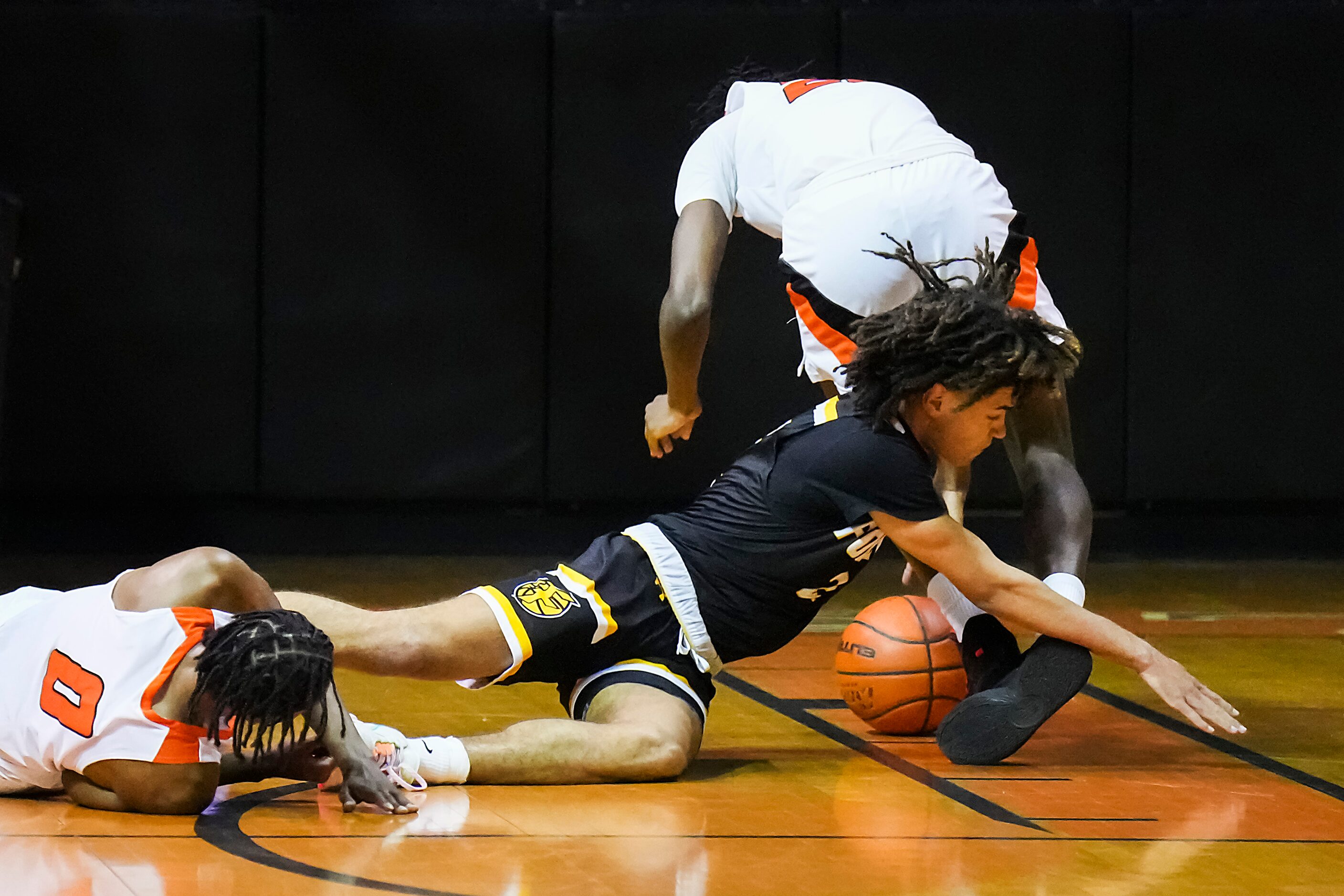 Forney guard Jackson Sanders (2) battles for a loose ball with Lancaster's Kade Douglas (0)...