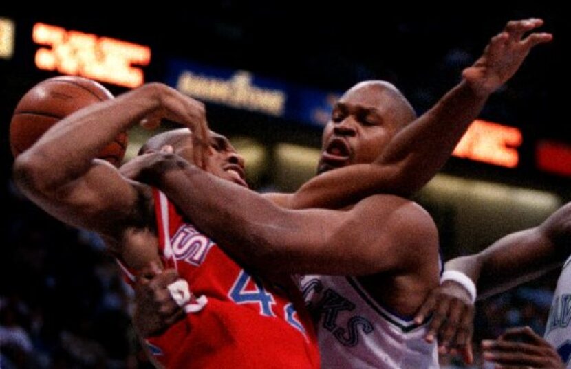 2/27/96--The Mavericks' Terry Davis gets  tangled up with The Philadelphia 76ers' Jerry...