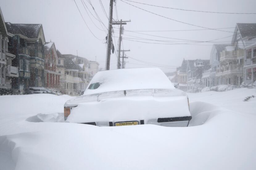 OCEAN GROVE, NJ: A vehicle parked on Abbott Avenue is surrounded by snowdrifts during a...