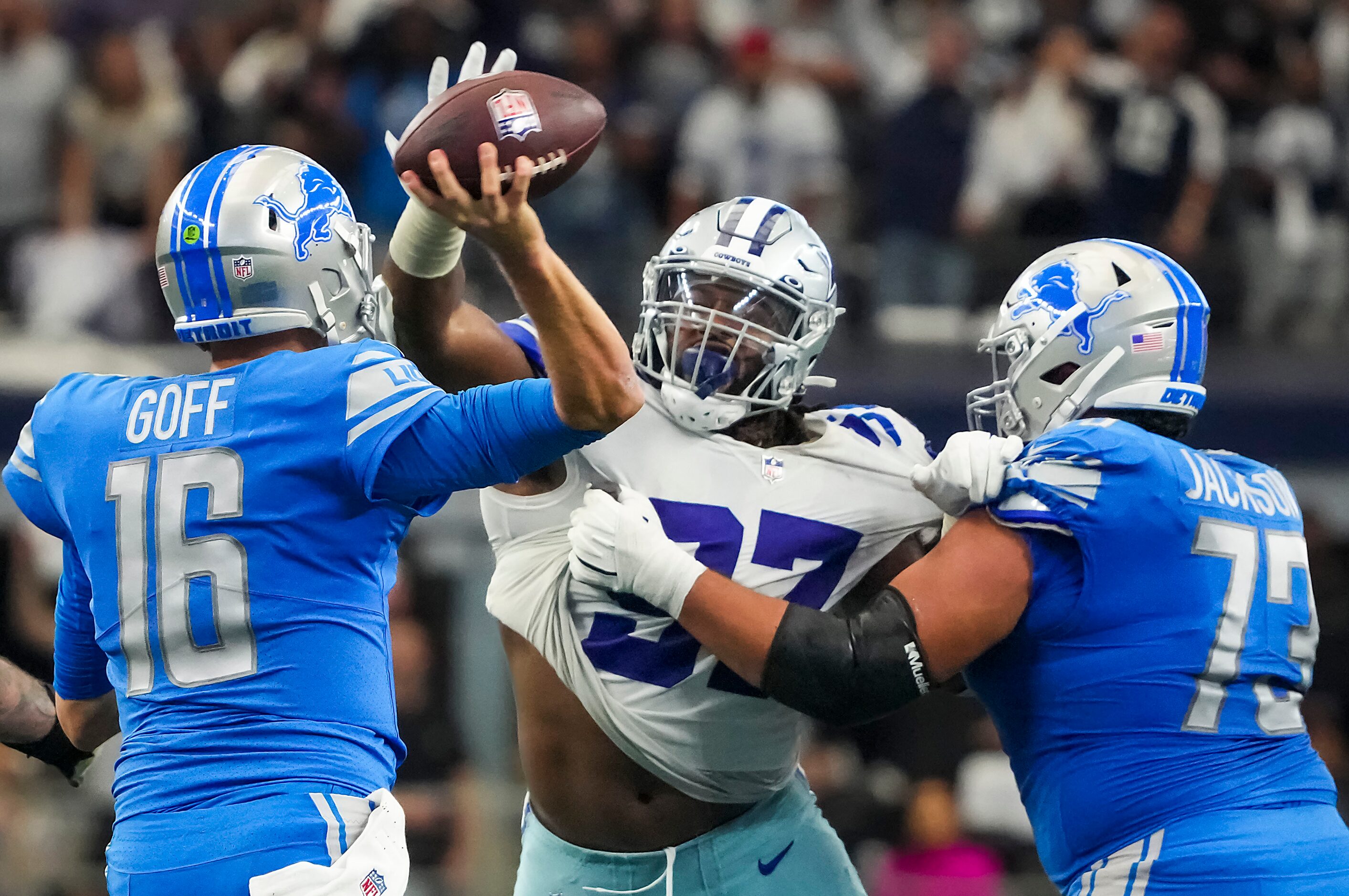 Detroit Lions quarterback Jared Goff (16) throws an interception under pressure from Dallas...