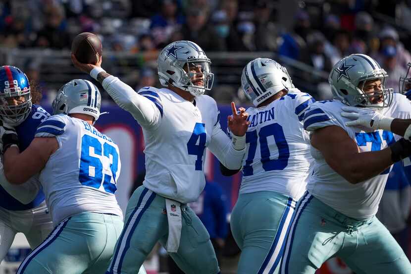 Dallas Cowboys quarterback Dak Prescott (4) throws a pass with protection from center Tyler...
