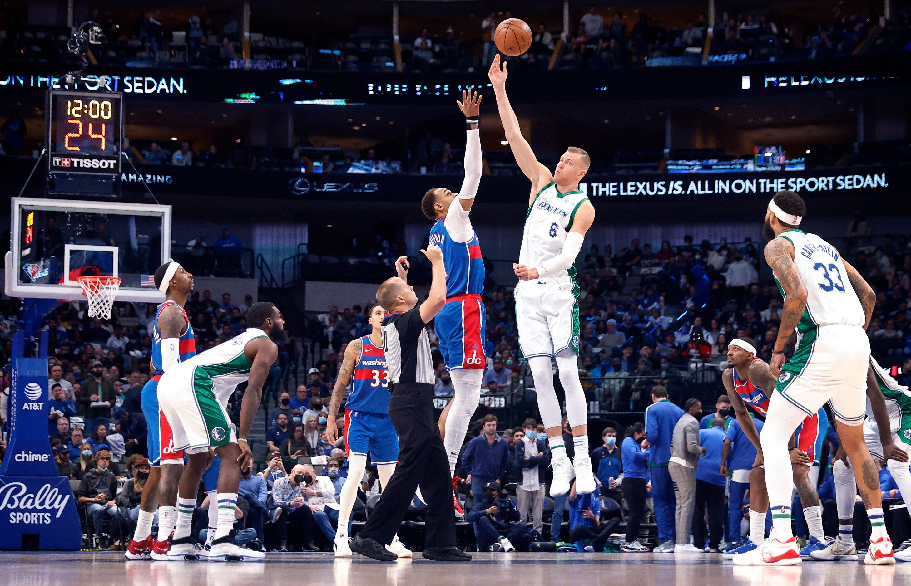 Dallas Mavericks center Kristaps Porzingis (6) soars for the opening tip against Washington...