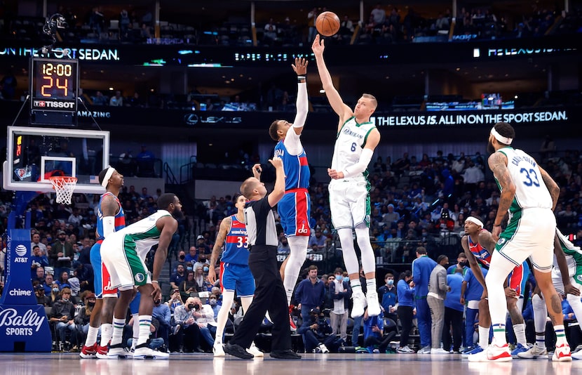 Dallas Mavericks center Kristaps Porzingis (6) soars for the opening tip against Washington...