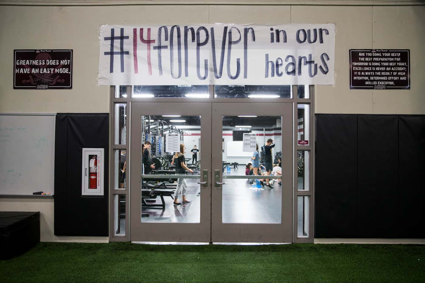 A banner is displayed outside the locker room honoring Wylie High School football player...