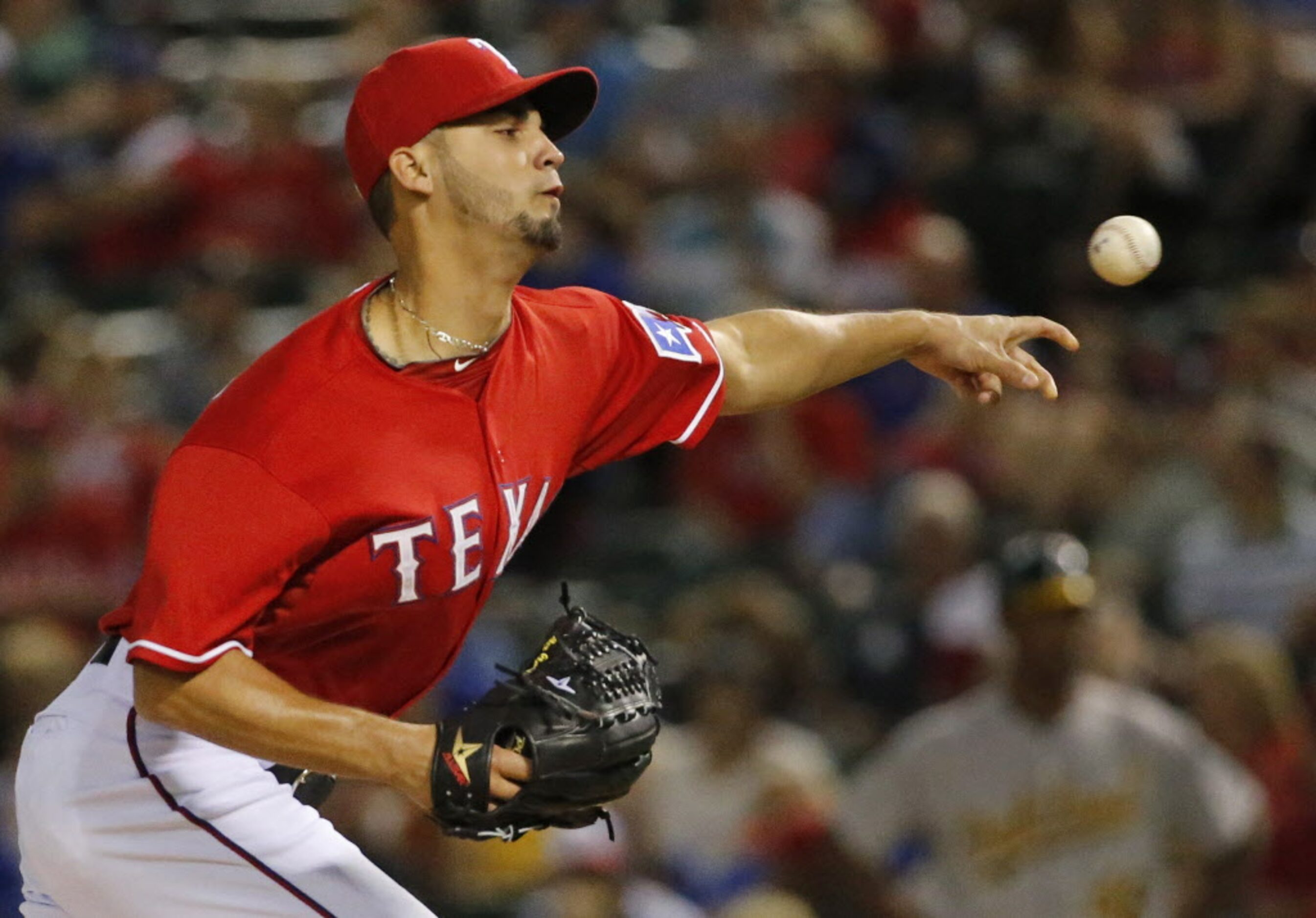 Texas relief pitcher Alex Claudio throws a pitch in the fifth inning during the Oakland...