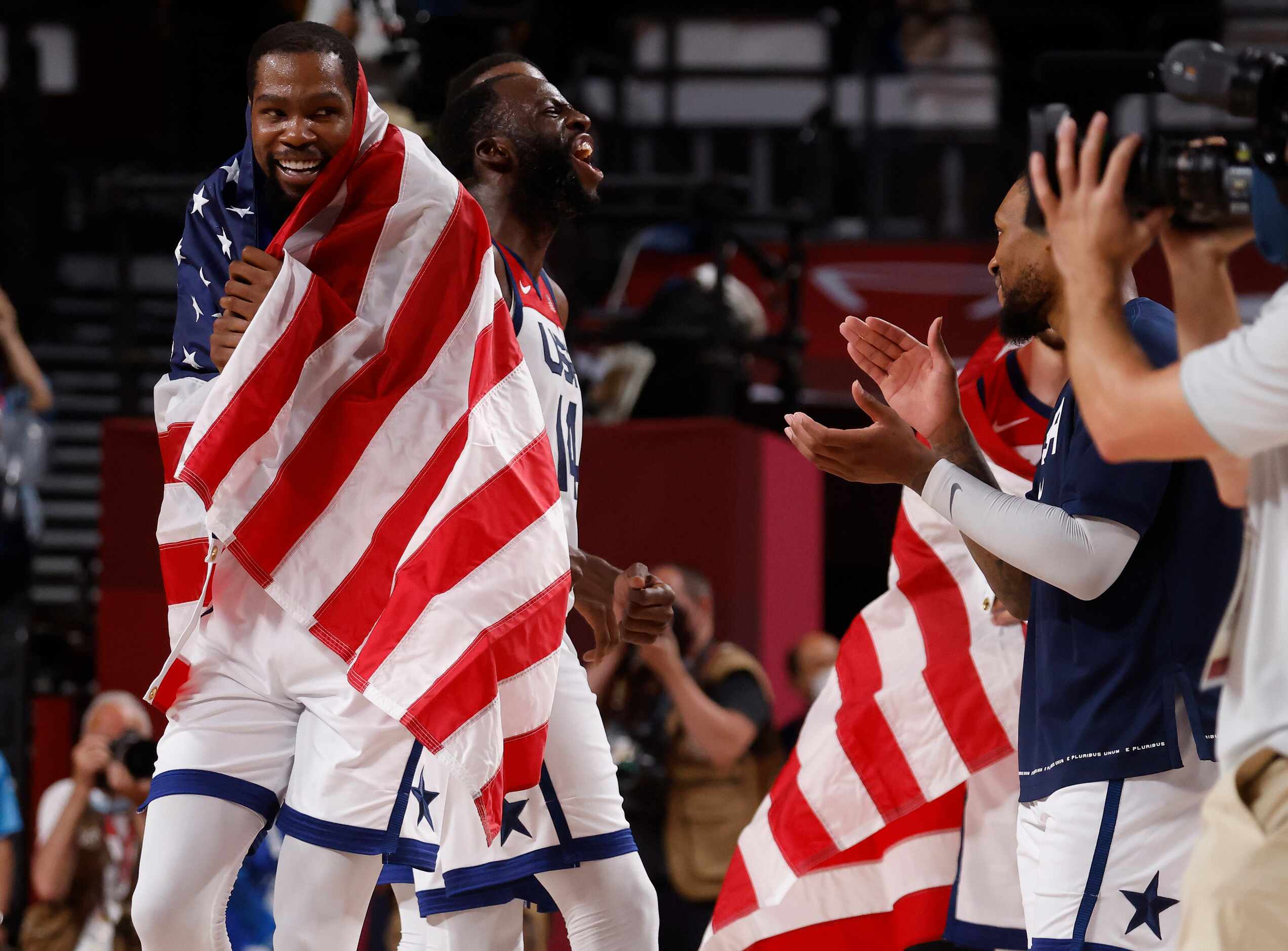 USA’s Draymond Green (14), Kevin Durant (7) and Damian Lillard (6) celebrate defeating...