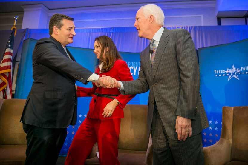 U.S. Sens. Ted Cruz, left, R-Texas, and John Cornyn, R-Texas, shake hands after having a...