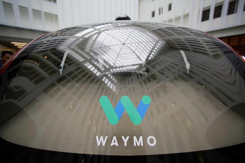 FILE - A skylight is reflected in the rear window of a Waymo driverless car during a Google...