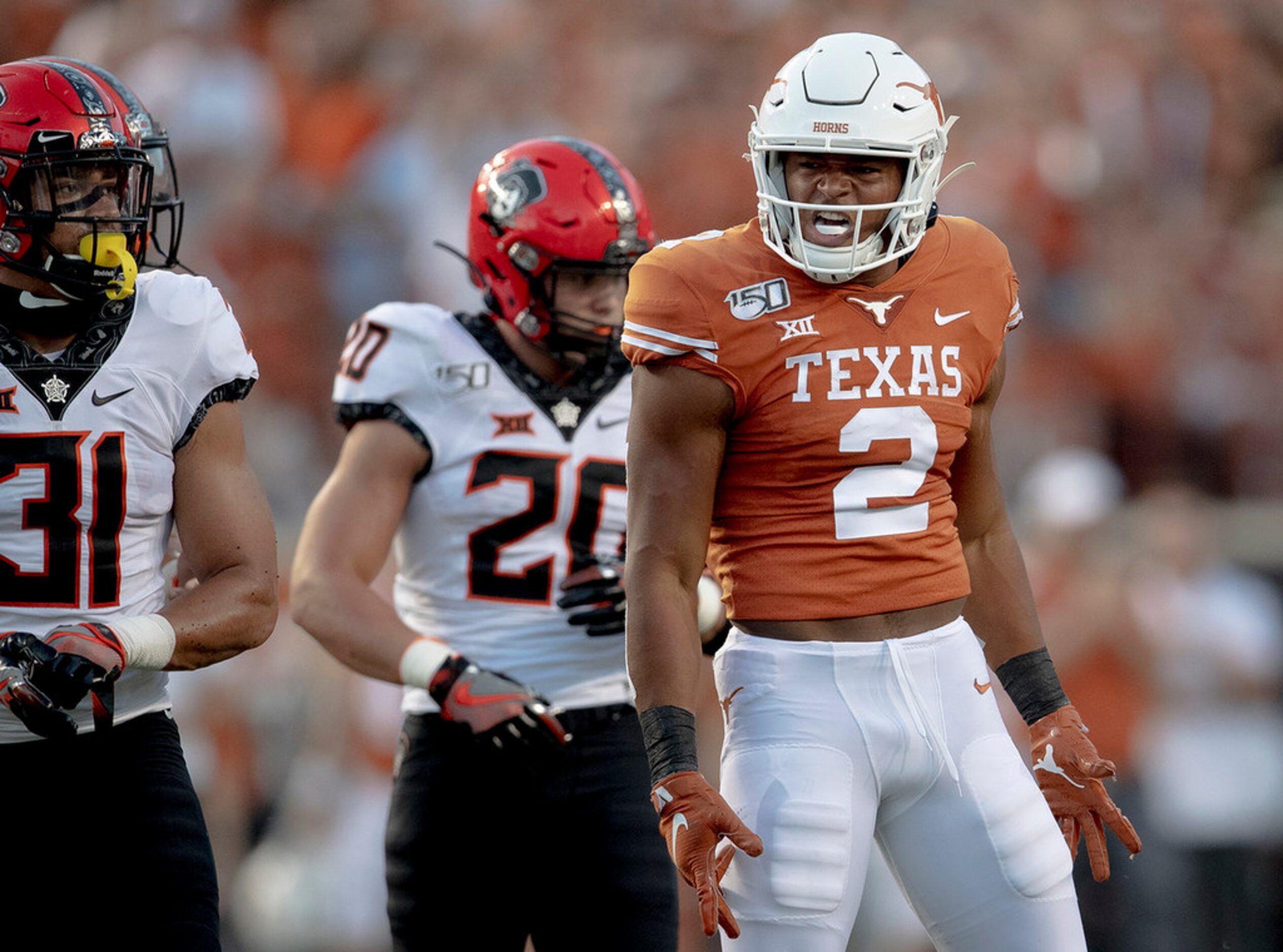 Texas running back Roschon Johnson (2) celebrates a first down against Oklahoma State on...