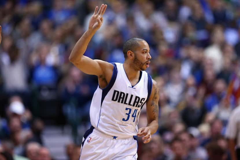 Devin Harris #34 of the Dallas Mavericks reacts after a three-point shot against the Dallas...