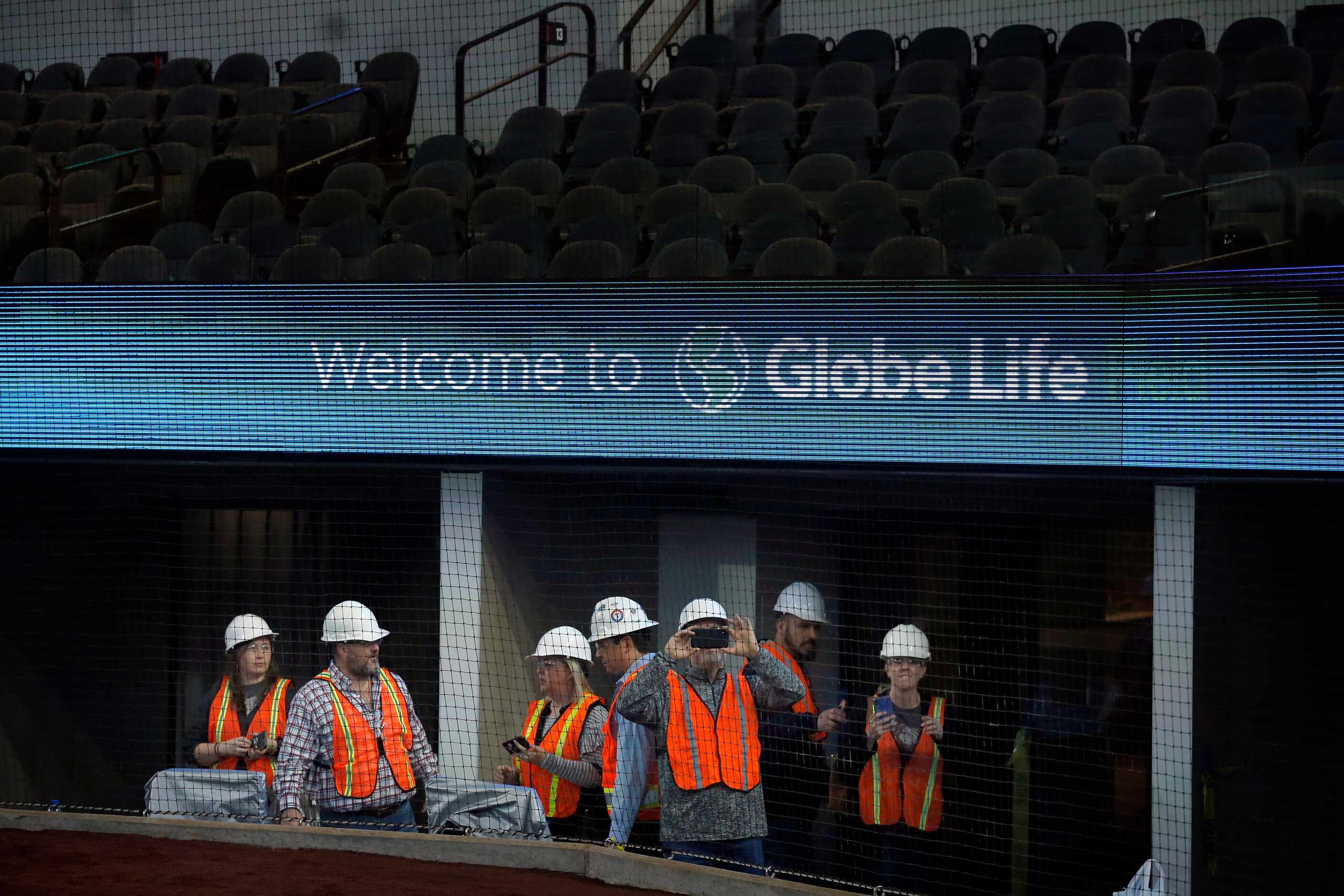 People tour the field level suites under construction in the new Globe Life Field in...