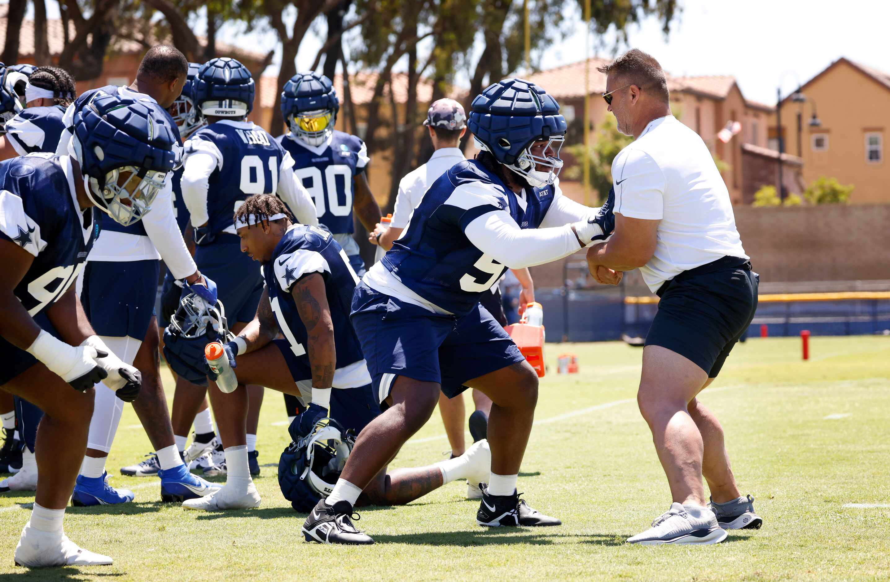 Dallas Cowboys defensive tackle Mazi Smith (58) works one-on-one with defensive line coach...