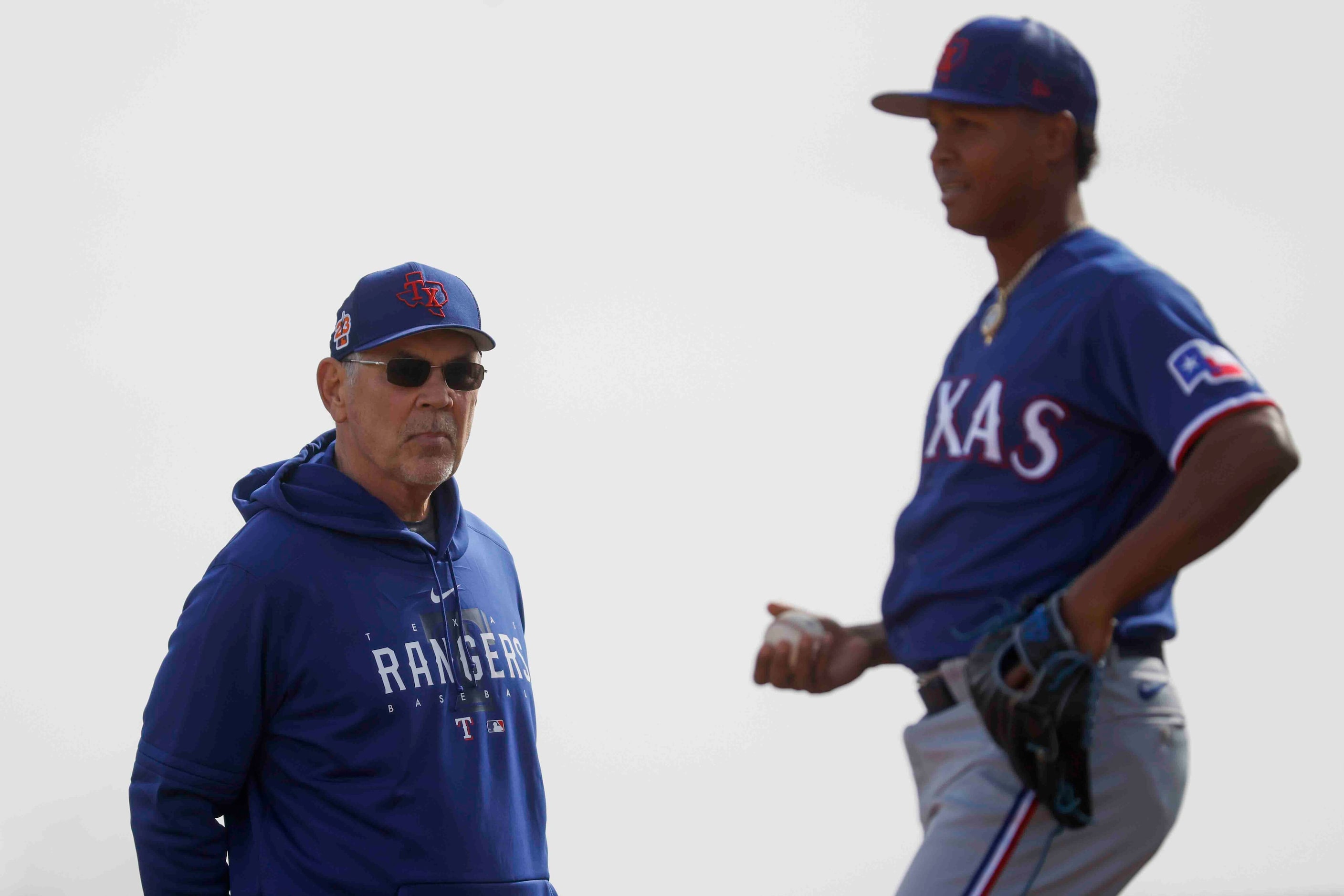 Texas Rangers manager Bruce Bochy, left, observes pitcher Jose Leclerc during spring...