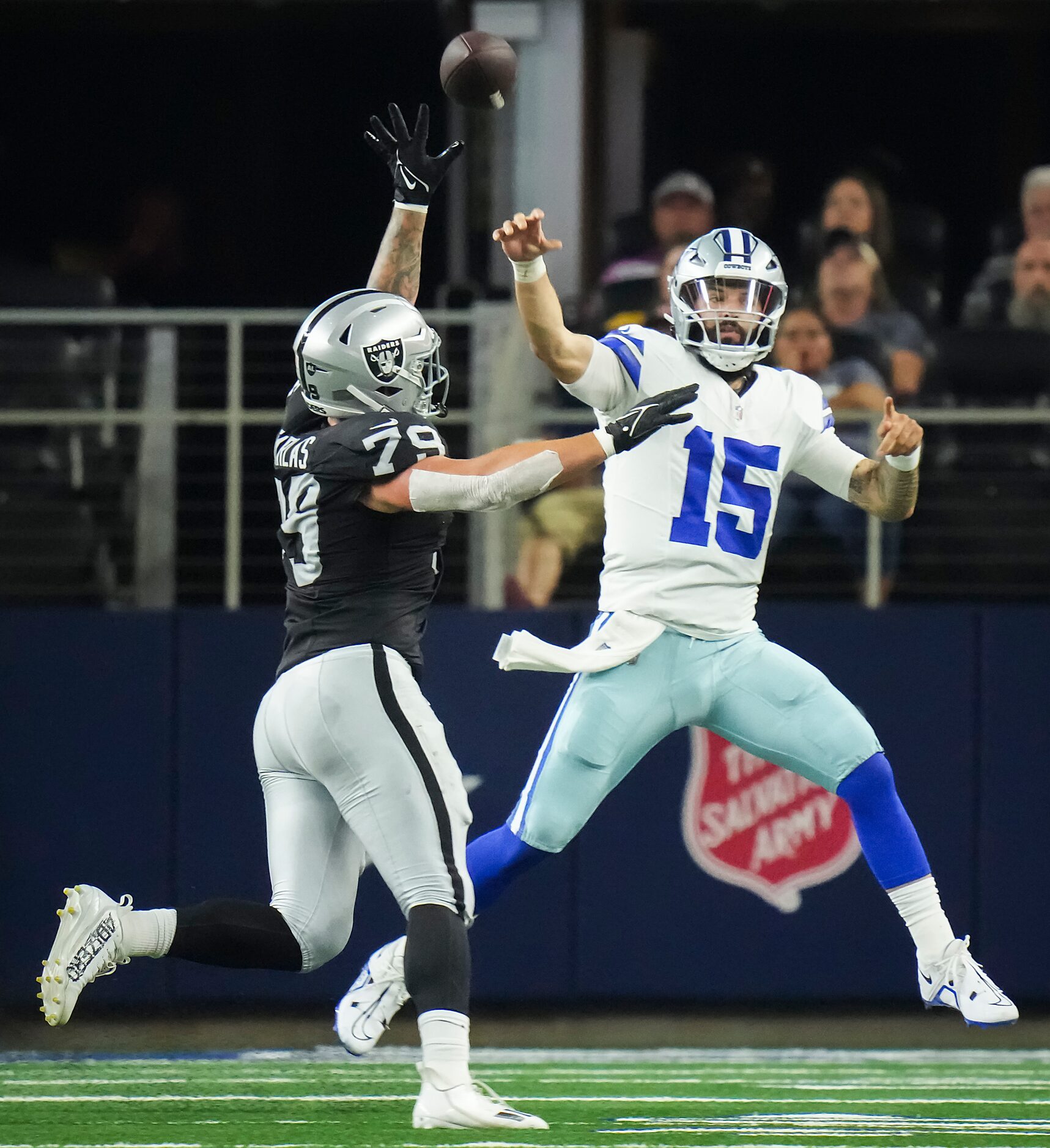 Dallas Cowboys quarterback Will Grier (15) throws a pass under pressure from Las Vegas...