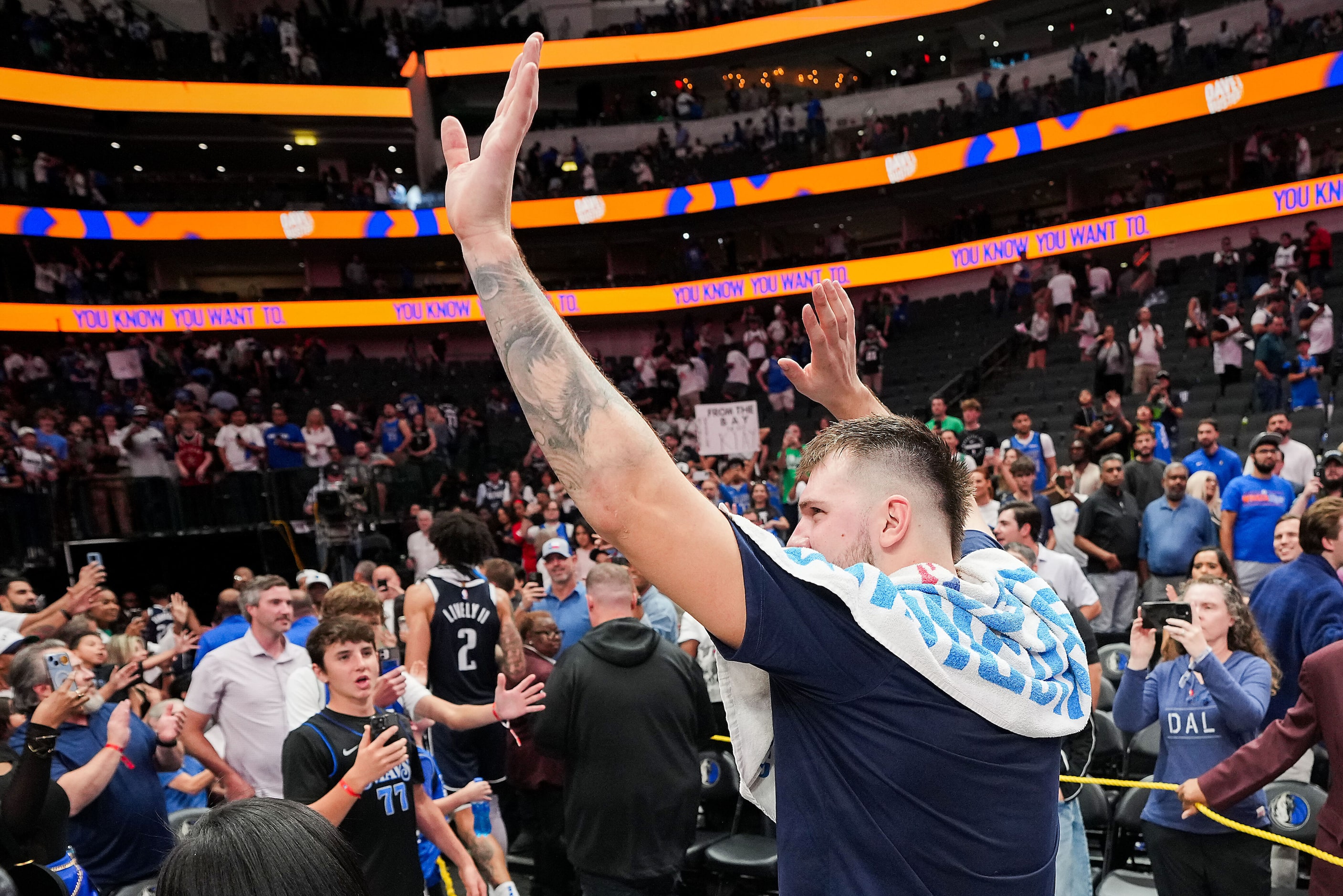 Dallas Mavericks guard Luka Doncic waves to the crowd as he leaves the court after the...