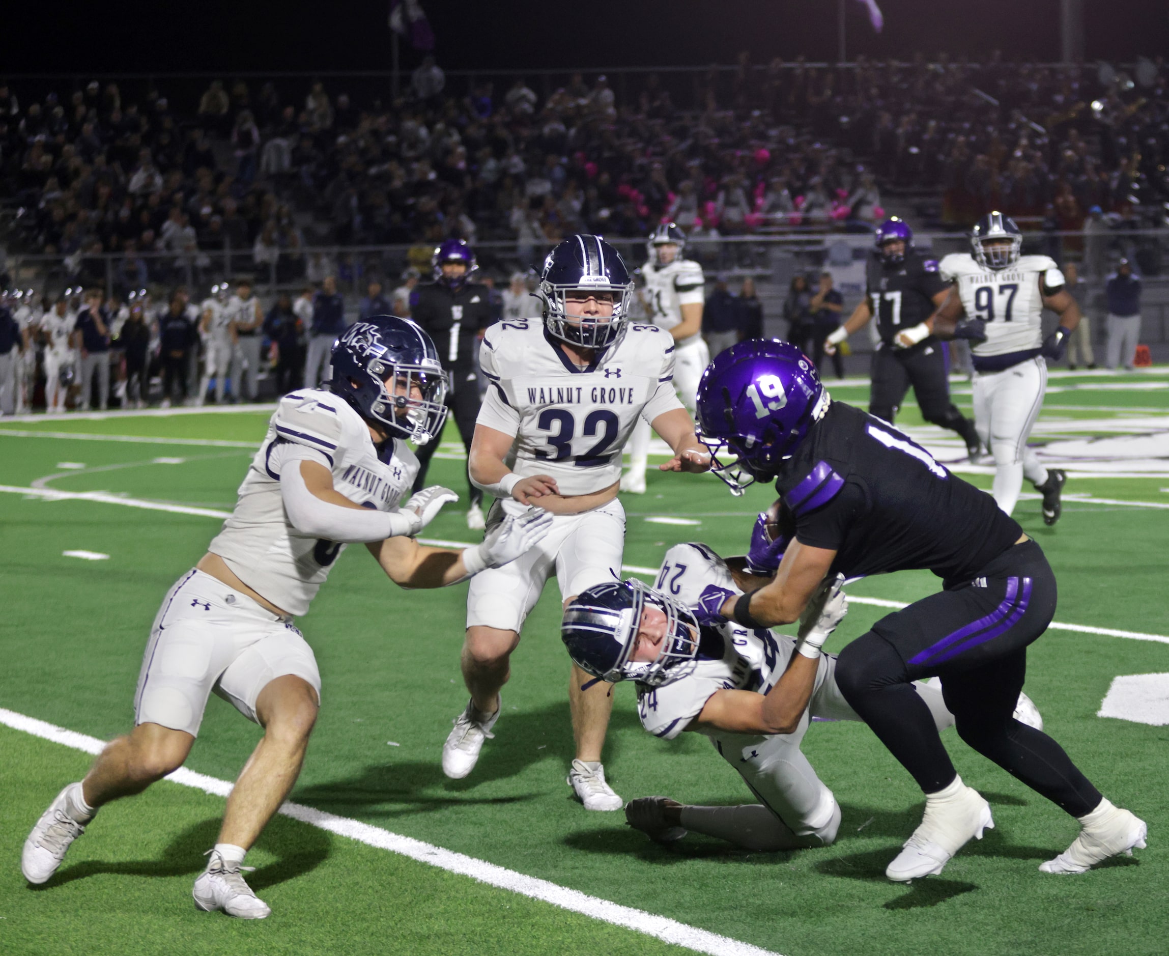 Walnut Grove player #24 Noah Sallaway pulls down by Anna player #19 Michael Kennedy during...