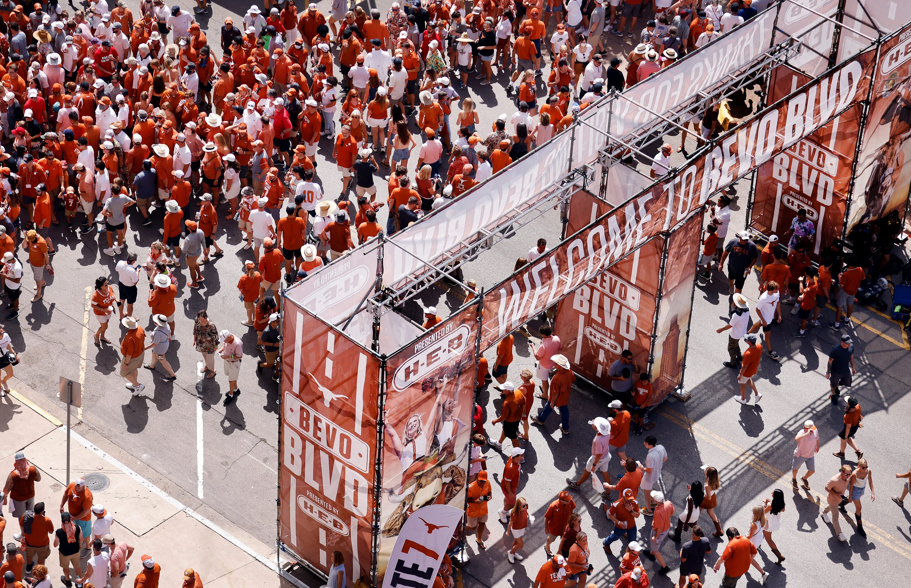 Fans file into DKR-Texas Memorial Stadium along Bevo Boulevard in Austin, Saturday,...