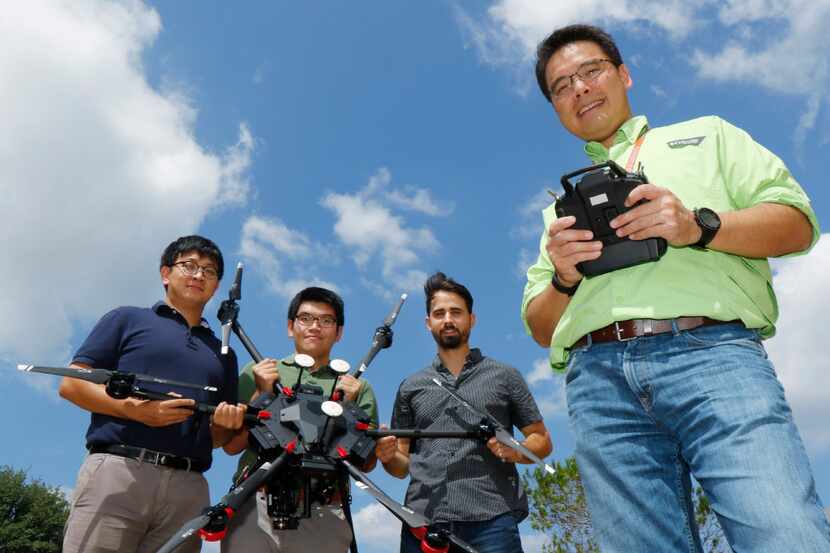 UT-Arlington professor Nick Fang with some of his graduate student and a drone that will be...