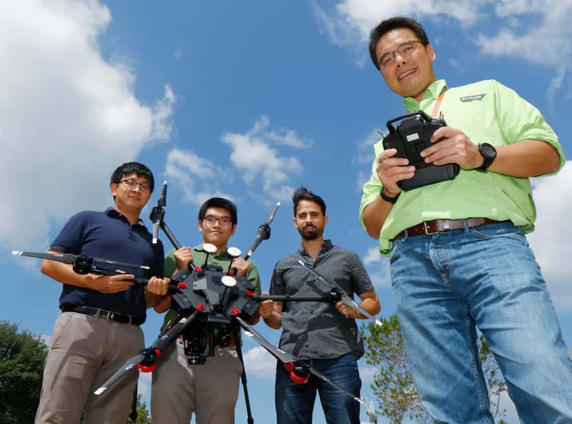 UT-Arlington professor Nick Fang with some of his graduate student and a drone that will be...