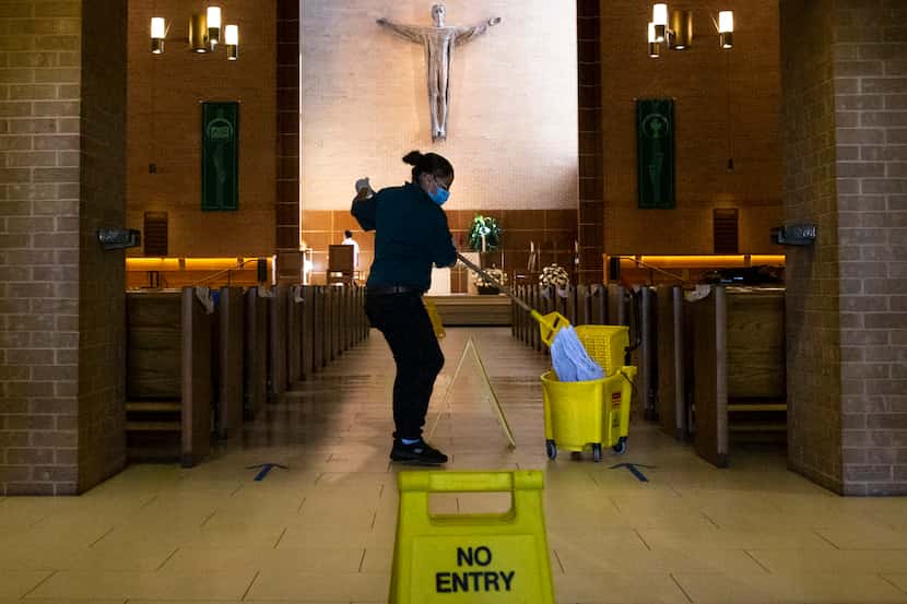 Nelida Juarez mops the floor of the St. Patrick Catholic Church in the Lake Highlands...