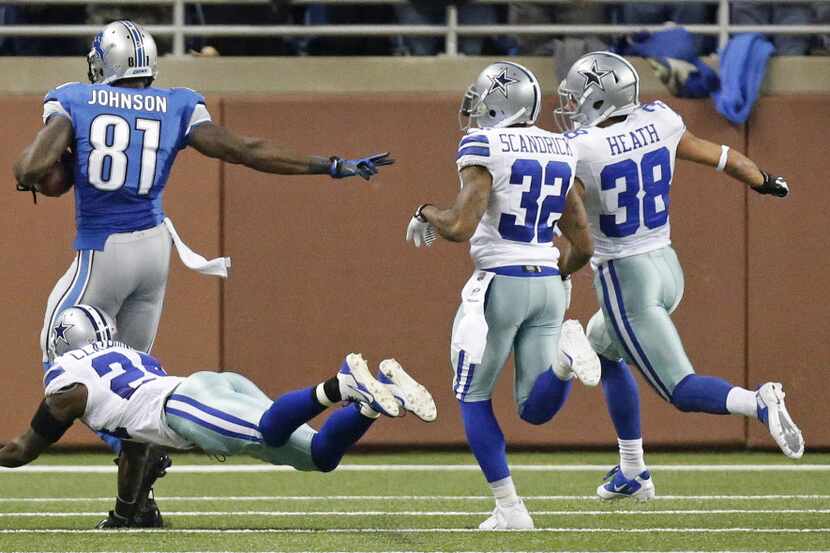 Detroit Lions wide receiver Calvin Johnson (81) tries to outrun Dallas Cowboys cornerback...