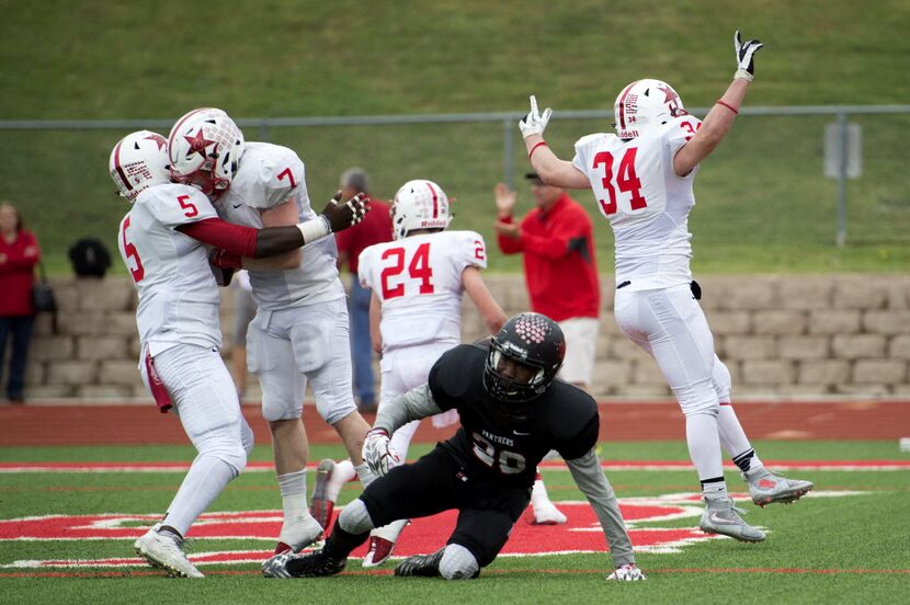 The Coppell defense celebrates after junior defensive back Joe Fex (7) knocked a potentially...