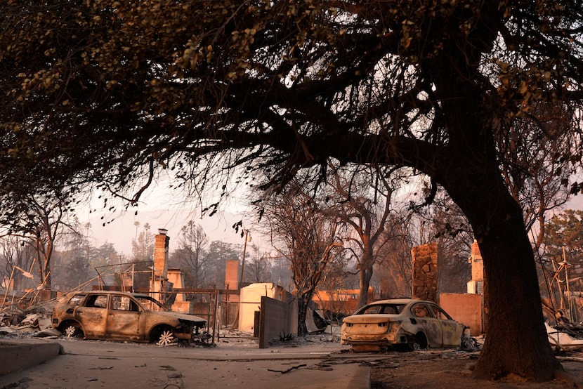 Burned-out cars lie near the ruins of homes destroyed by the Eaton Fire, Thursday, Jan. 9,...