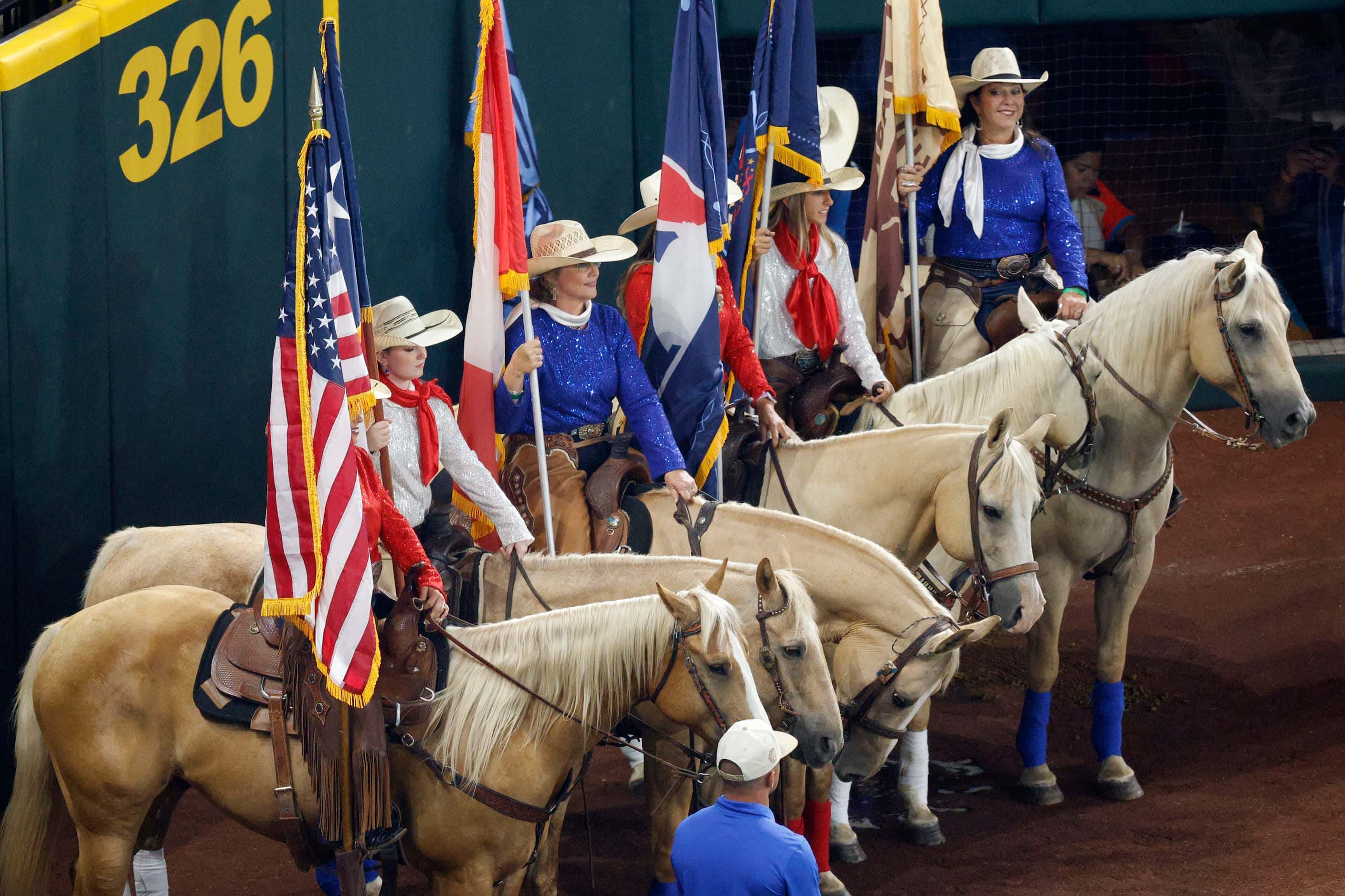 Horse riders line up with holding flags before the MLB All-Star baseball game at Globe Life...